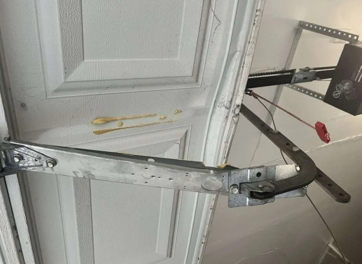 a professional technician performing garage door track repair in South Miami, FL, showcasing expertise and high-quality service.