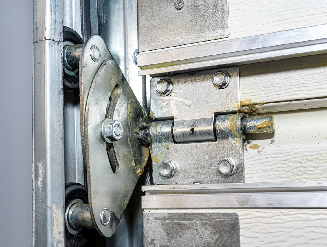 Technician repairing a noisy garage door in South Miami, FL - expert fix service