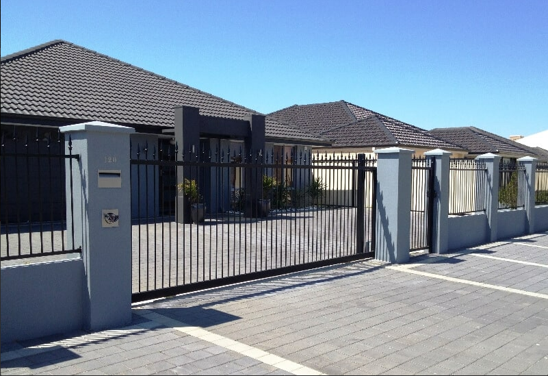 a technician repairing a commercial gate in South Miami, FL, highlighting the professional garage door repair services offered.