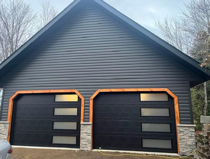 Close-up of a technician fixing a garage door panel in South Miami, FL, showcasing professional repair services with tools and safety equipment.