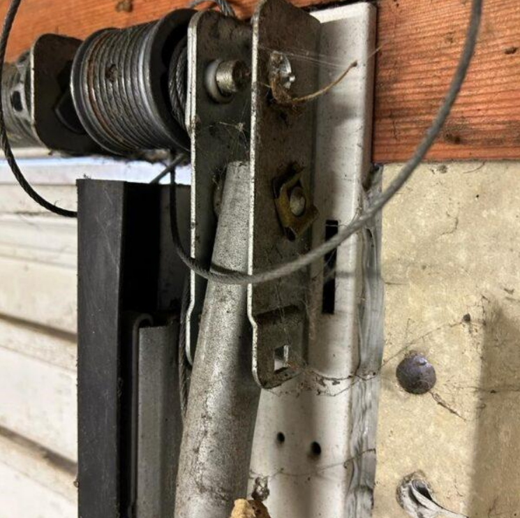 Close-up image of a technician repairing a garage door cable in South Miami, FL, part of our efficient garage door repair services.